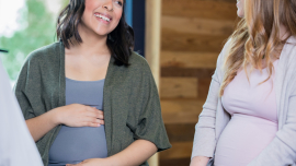 Two pregnancy women laughing