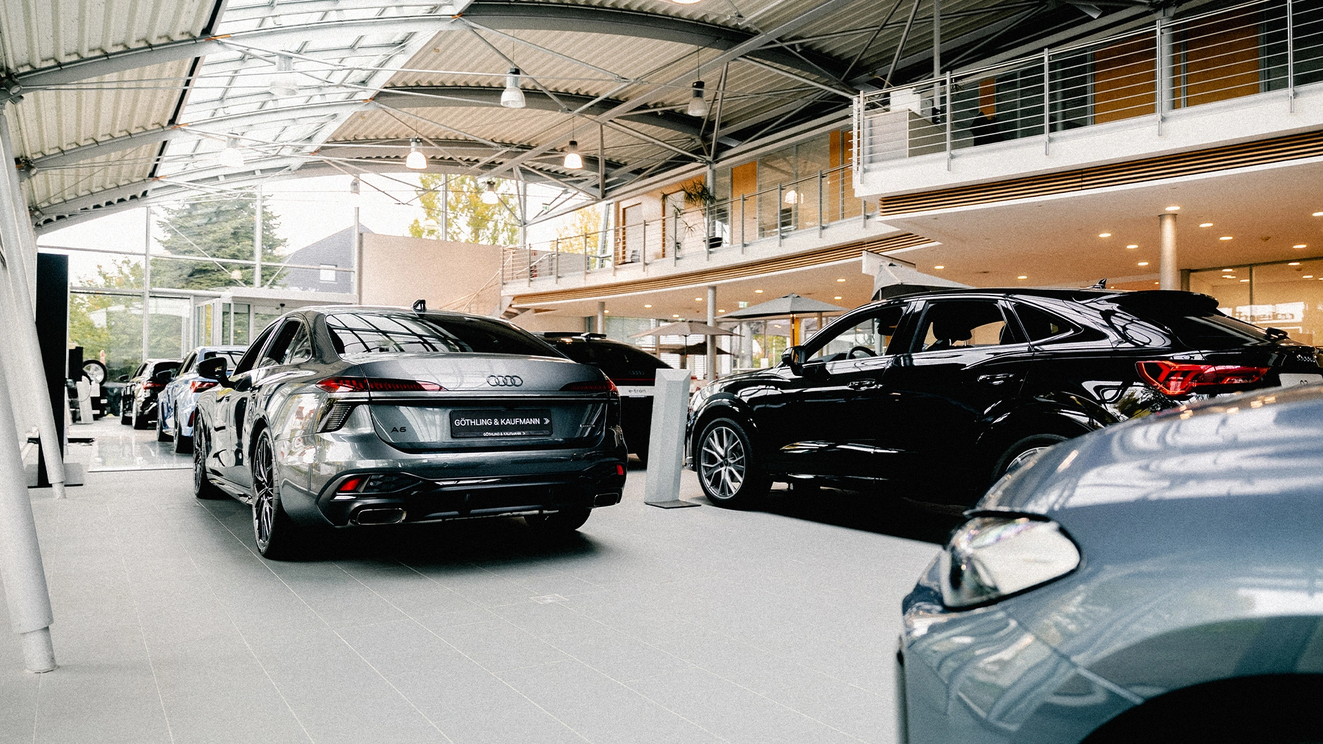 Göthling & Kaufmann Header Eine Innenaufnahme des Audi Zentrums in Hofheim am Taunus, die den Showroom und einige Audi Modelle zeigt.