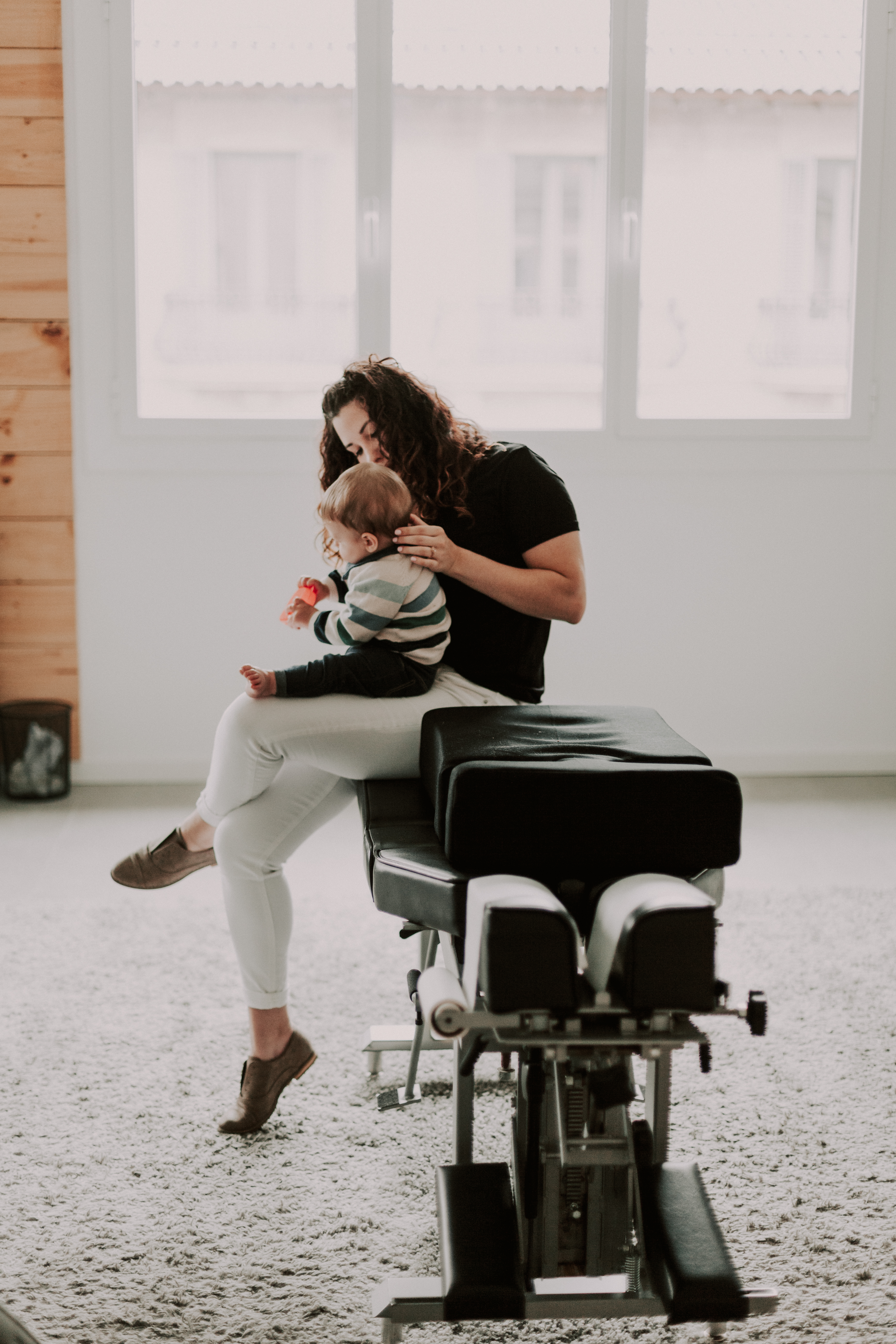 Illuminnate chiropractic studio's chiropractor Kelli Turelli adjusting a baby patient in Barcelona Spain