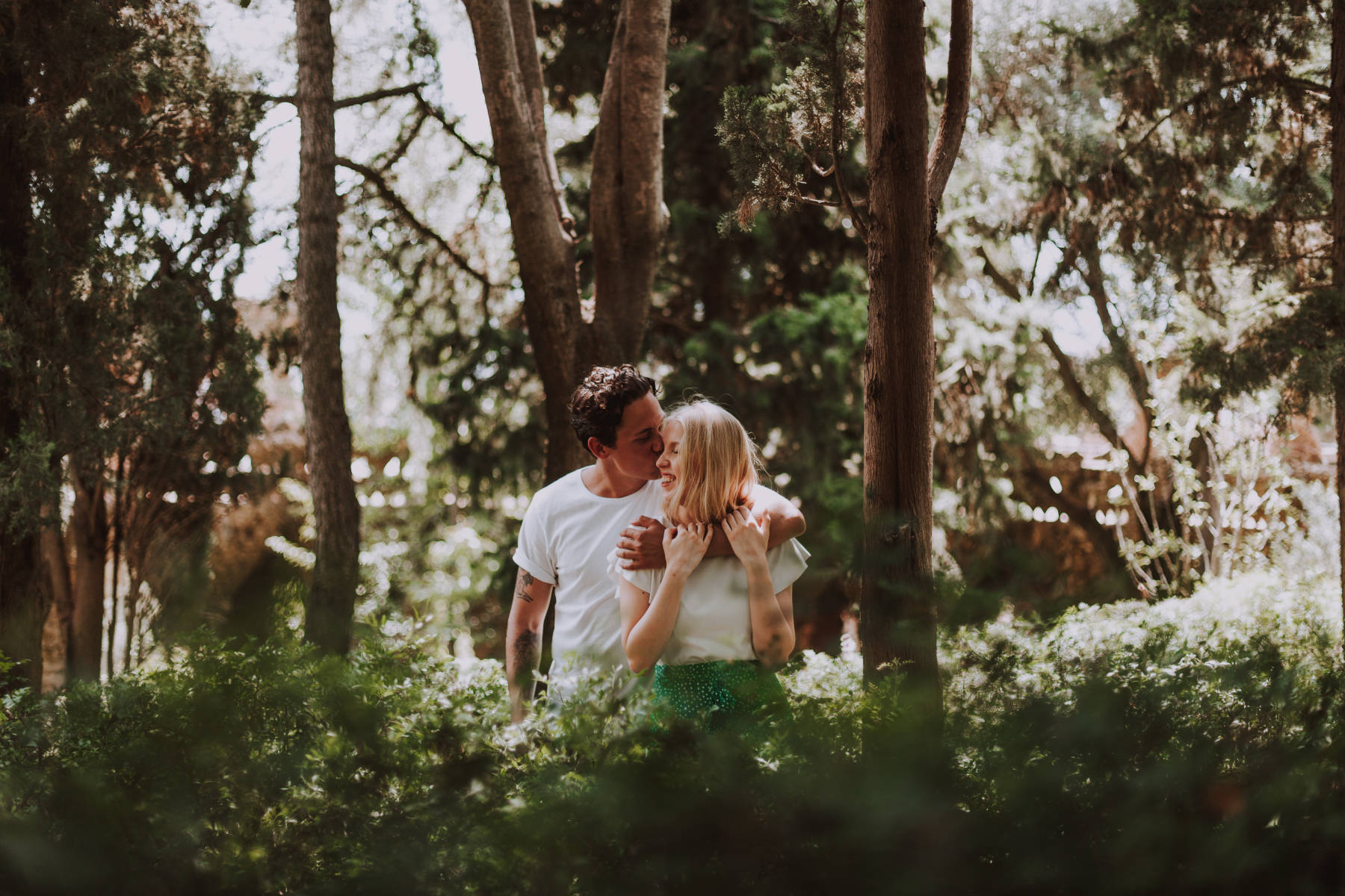 Couple posing in a forest in park de guell Barcelona Spain during a couple photoshoot