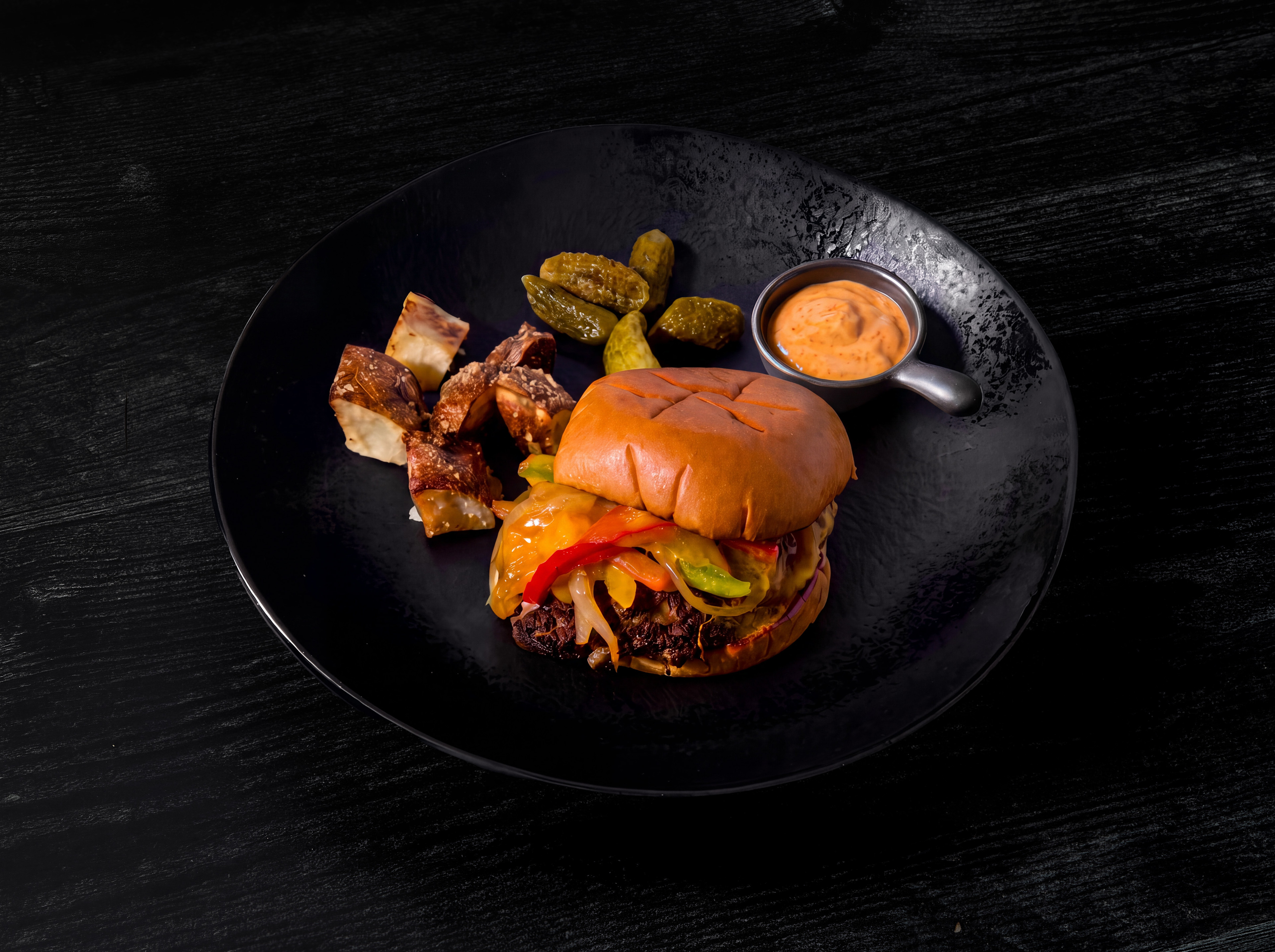 Beautifully plated Philly cheesesteak burger made by Chef Ruben Garcia