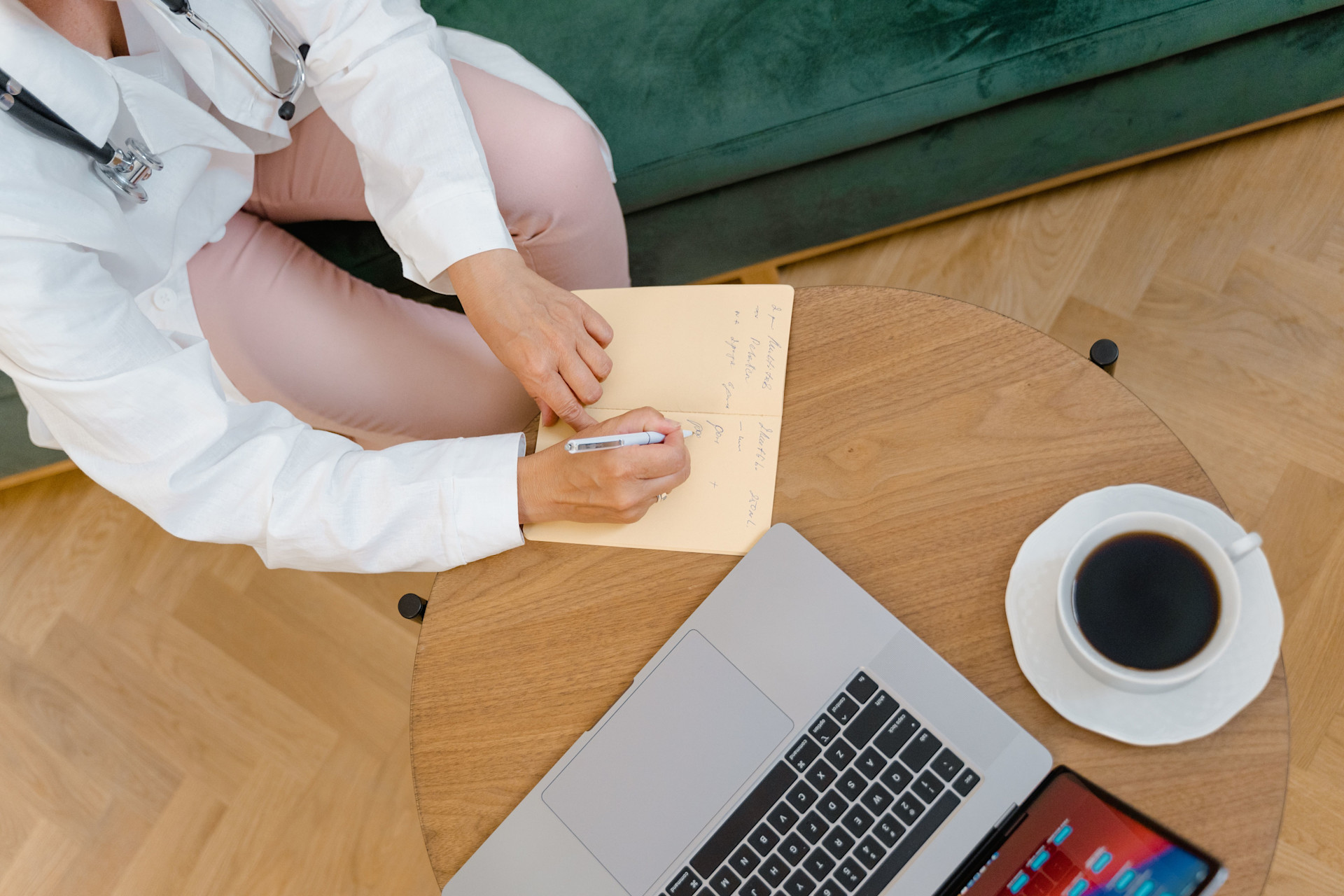 Doctor is discharging a patient from the hospital with a cup of coffee on their table