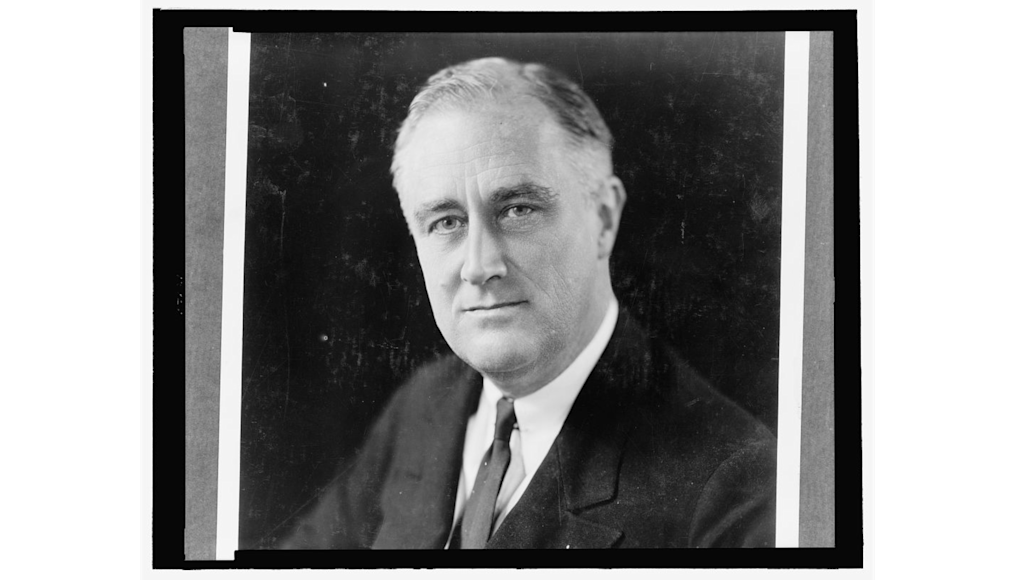 The picture depicts a black and white photo of president Franklin Delano Roosevelt. In the picture, he stares directly out at the viewer.