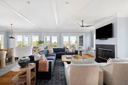 A comfortable living room on Isle of Palms with a beamed ceiling and fireplace, perfect for holiday gatherings.