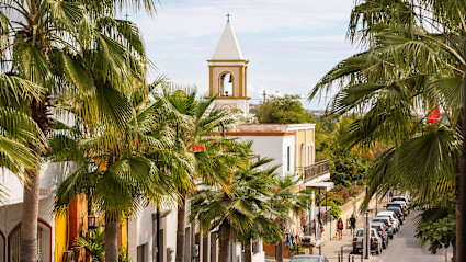 A stock photo shows a bell tower in San Jose del Cabo.
