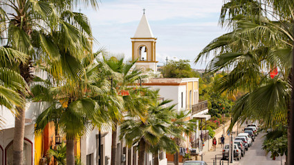 A stock photo shows a bell tower in San Jose del Cabo.
