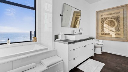 A bathroom of a Malibu vacation home with a sink, tub and ocean views


