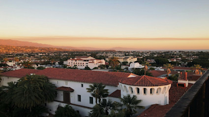 A Spanish-style landmark at sunset highlights the red-tile roofs and arches that inspire Santa Barbara’s modern estates.