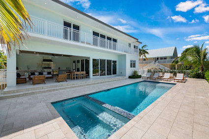 Sunset Park features a backyard with a pool, hot tub, and patio, providing a relaxing setting to enjoy evenings after the festival at Mallory Square.