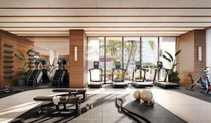 Bright residential fitness center with treadmills, stair climbers, spin bikes, and free weights, featuring wood accents and floor-to-ceiling views of palm trees.
