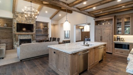 Open floor plan kitchen and living room with wood beams