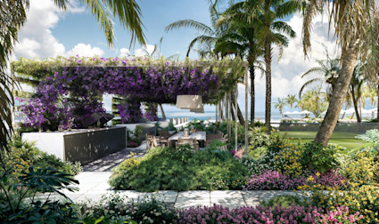 Outdoor summer kitchen and dining area under a bougainvillea-draped pergola, surrounded by tropical gardens, palm trees, and ocean views.