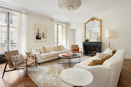 Parisian living room details like chevron floors, molding and a refined palette show how quiet luxury elevates winter city living.