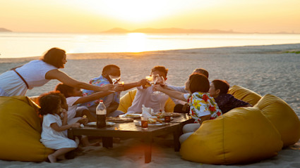 A joyful beachfront toast at sunset captures the essence of relaxed, luxurious outdoor entertaining with friends and family, echoing the possibilities in every Pacaso destination.