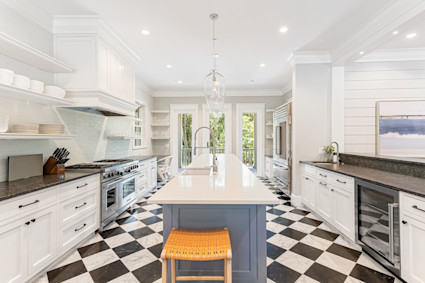 A spacious kitchen with a large island and high-end appliances, showcasing Charleston's emergence as a food destination and its impact on luxury real estate features.