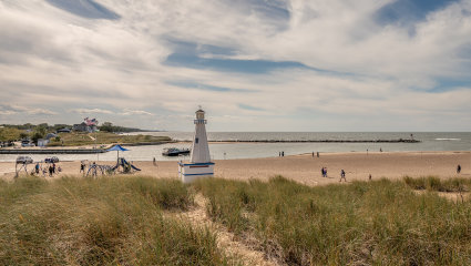 A lighthouse sits on the sparsely populated beach of New Buffalo, Michigan, embodying why it’s one of the best places for a second home.