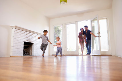 A family enters the new home they purchased after researching current real estate facts.