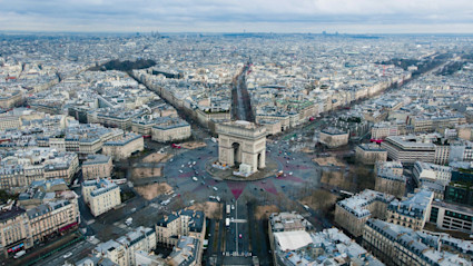 Aerial view of Paris with the Arc de Triomphe, reflecting the grandeur and thoughtful design underpinning the city’s luxury homes.