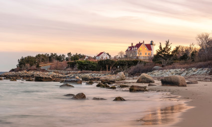 A beach with rocks and crashing waves