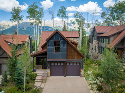The front exterior of a modern mountain home in Telluride, representing a luxurious and comfortable base for enjoying the ski season.