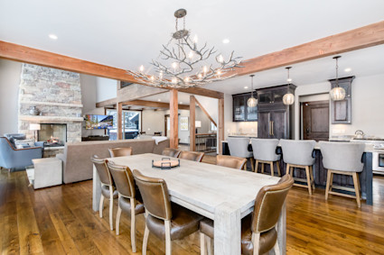 Windwood’s dining area in Breckenridge is ideal for a festive Thanksgiving table, blending a wood beam ceiling, fireplace, and mountain-inspired ambiance.