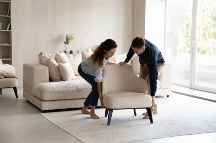 Two people pushing a chair