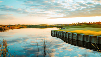 A sunset over Kiawah's golf course and waterways, highlighting the blend of natural beauty and premium amenities.