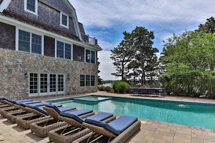 Fox Hill's pool and patio showcase the indoor-outdoor living that defines high-end Cape Cod homes.