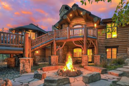 wood cabin estate with large balcony and fire pit