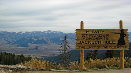 A Jackson Hole welcome sign and striking mountain backdrop set the scene for a destination that unites music, art, and alpine adventure.