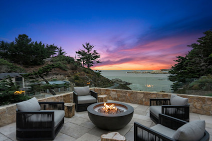 Hillside in Carmel features a terrace with water views and a fire pit, perfect for enjoying crisp evenings and connecting with friends or family.