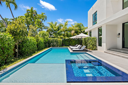 A saltwater pool and hot tub at Casa Estrada in Miami Beach, showcasing resort-style amenities for second home living.