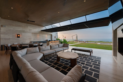 Miramar showcases expansive indoor outdoor flow with a living room that opens to panoramic water views and a heated pool and spa for winter use.