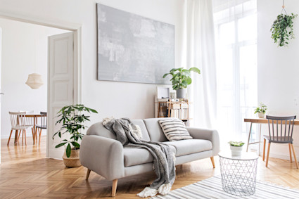 a modern white living room with a couch and a table