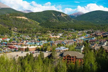 View of a small town surrounded by trees and mountains