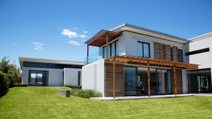 A luxury house with a well-manicured lawn shows the potential of co-owning a home.