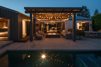 Family sitting around the firepit of their luxury vacation home