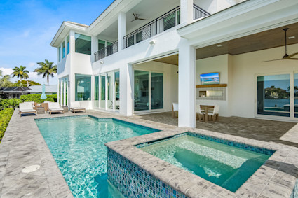 An inviting swimming pool and covered patio at Windmill Palms on Marco Island, highlighting the relaxing, luxurious options available.