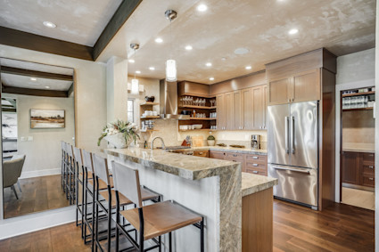 Rodeo in Pebble Beach features a modern kitchen with a breakfast bar and premium appliances, making it a perfect home in Carmel for gourmet cooking and elegant dining.