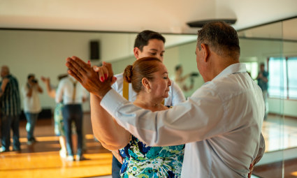 A couple enjoys a dance lesson, one of the many hobbies for empty nesters.