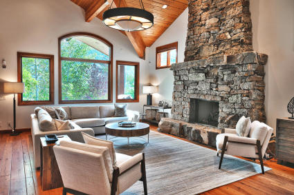 Rustic living room with a large stone fireplace