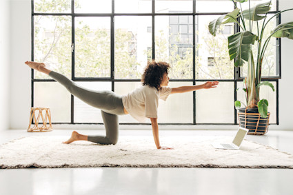 A woman performs yoga on the floor, putting her own spin on a popular zen room idea.