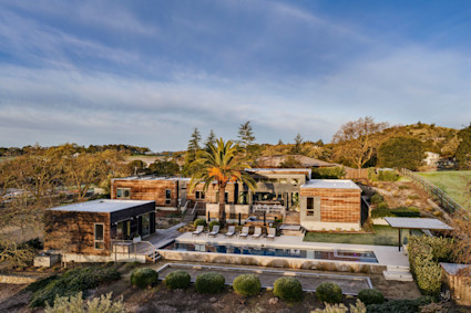 The Palm, Pacaso home in Napa CA — aerial with pool, lone palm, and rolling hills (260220_The_Palm_DJI_0392, February 2026 shoot). Used as the /sell page hero.