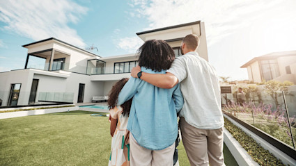 A couple looks at a home after browsing the best house buying websites.