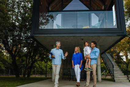 A family takes a tour of a luxury home as they pursue their goal of buying a vacation home.
