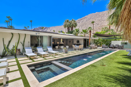 A luxury home in Palm Springs has views of the mountains from the comfort of its backyard pool, showcasing why this city is one of the top vacation destinations in the country.
