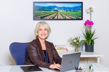 Elizabeth Olcott sitting at desk