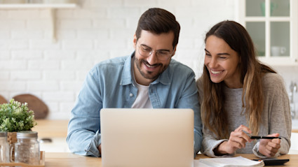 Smiling young couple planning budget