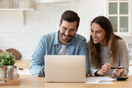 Smiling young couple planning budget