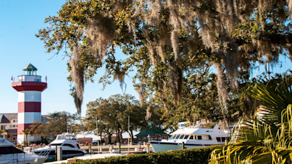 The harbor and lighthouse at Hilton Head set the tone for refined coastal living, which is echoed in the interior palettes and relaxed outdoor living spaces of area homes.